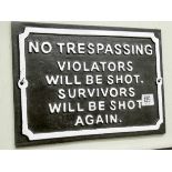 A cast iron wall hanging 'No Trespassing' sign