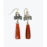 A pair of carnelian bloodstone drop earrings with a floral motif at the top, approximate weight 9.