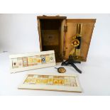 A Dolland & company microscope with two boxes of slides