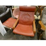 A rocking fireside chair with green leather seat and back and a matching foot stool
