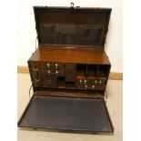 An antique look, leather effect travelling chest, fitted interior drawers and pigeonholes,