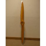 A large wooden airplane propeller,