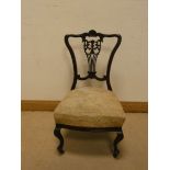 An Edwardian dark mahogany bedroom chair with upholstered seat,
