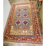 A red and patterned wool pile Persian rug 8'6 X 5'3