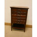 An Edwardian mahogany music cabinet, fitted five drawers with shelf under,