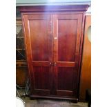 A modern mahogany two door wardrobe with interior mirror,