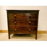 Victorian mahogany chest of three long drawers with bun handles standing on reeded style legs