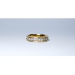 A 14ct yellow gold wedding band set with 11 brilliant cut diamonds, ring size U,