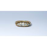 An five stone diamond ring set in 18ct yellow gold, with floral motifs on shoulders,