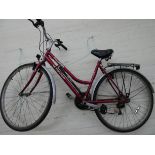 A mauve and silver Pro-bike Voyager ladies bicycle with rear rack