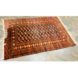 A red and patterned Bokhara rug,