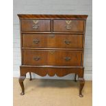 A Georgian style mahogany chest of two long and two short drawers, standing on cabriole legs, 31.