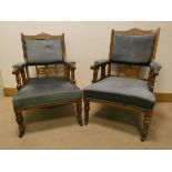 A pair of Edwardian inlaid mahogany framed elbow chairs upholstered in blue covering