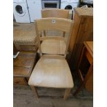 A pair of modern light beech kitchen chairs