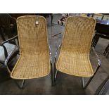 A pair of chrome framed cane seat and back elbow chairs