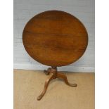A Georgian circular oak snap top table on pillar and tripod base,