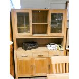 A heavy good quality light oak dresser with glazed and shelf back,