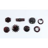 A collection of garnet look paste vintage brooches,