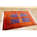 A red and patterned blue square design fine pile Persian rug,
