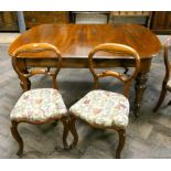 A set of six Victorian oak balloon back dining room chairs standing on cabriole legs with tapestry