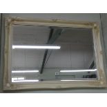 A large bevelled wall mirror in Victorian style decorative cream frame