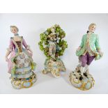 A pair of 19th Century coloured Bisque figurines of a lady and gentleman together with a floral