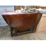A mahogany oval gate leg dining table on turned legs 3'6 wide