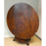 A Victorian circular mahogany fold over top breakfast table on pillar and platform base with paw