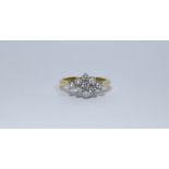 An 18ct diamond shaped ring set with 9 brilliant cut diamonds, ring size M, approximate weight 4.