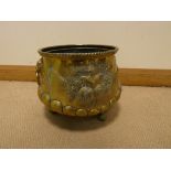 A circular brass fruit embossed jardiniere or coal bin with brass iron handles