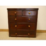 A Victorian mahogany chest of three long and two short drawers with bun handles,