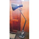 A black metal angle poised desk lamp