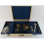 A cantilever jewellery box containing ladies wristwatches, broaches,