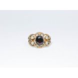 A 9ct ladies dress ring set with a garnet and four white stones size Q, approximate weight 4.