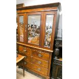 A Victorian walnut linen press with two long and two short drawers under with decorative mirror