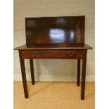 A Georgian III mahogany folding top tea table, fitted one long drawer, on square reeded legs,