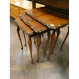 A nest of three mahogany coffee tables on fine cabriole legs