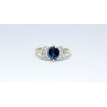 A sapphire and diamond cluster ring set in 18ct yellow gold, ring size I,