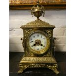 A French striking mantel clock by Japy Freres in decorative brass case with urn shaped finial