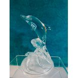 A frosted glass model of a dolphin,