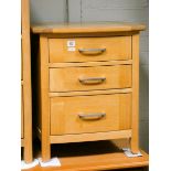 A pair of heavy quality light oak bedside chests, each fitted three drawers,