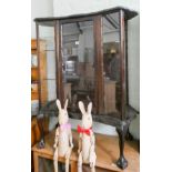A mahogany shaped front china display cabinet standing on claw and ball feet