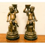 A pair of Victorian style bronze Cupid candlesticks on heavy bases with marble plinths, 14" high,