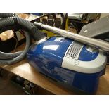 A blue Miele cylinder vacuum cleaner