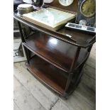 An Ercol oak three tier tea trolley