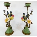 A pair of decorative gilt metal and porcelain mounted candlesticks decorated with finches and