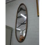 A long oval mirror in gilt frame