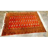 A red and patterned fine pile Persian rug,