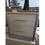 A light beech two drawer bedside chest matching the previous lot