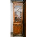 A reproduction yew wood glazed bookcase with cupboard under,